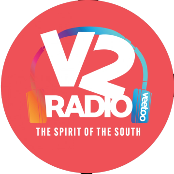 V2 Radio logo with colorful headphones and the slogan The Spirit of the South on a red circle background.